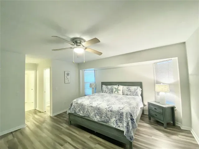 a bedroom with a large bed and a chandelier