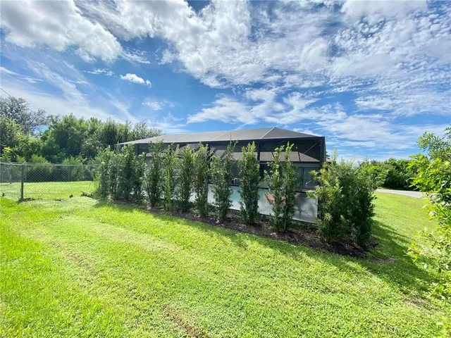 a backyard of a house with lots of green space and garden