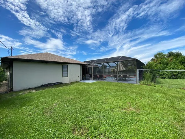 a view of backyard with seating and green space
