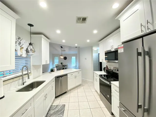 a kitchen with a sink stainless steel appliances and cabinets