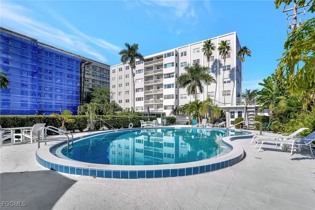 a view of a swimming pool with sitting area