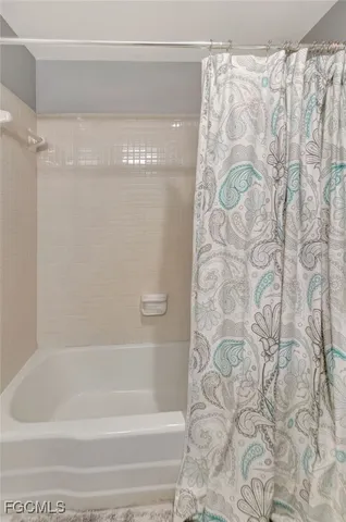 a bathroom with a bathtub and shower