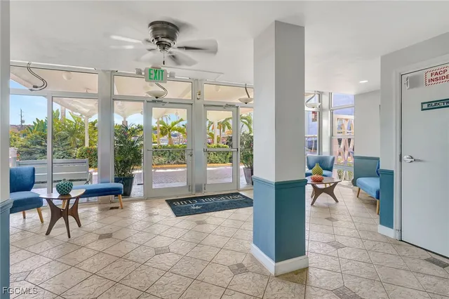 a living room with furniture and large windows