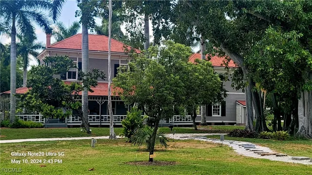 a front view of a house with a yard table and chairs