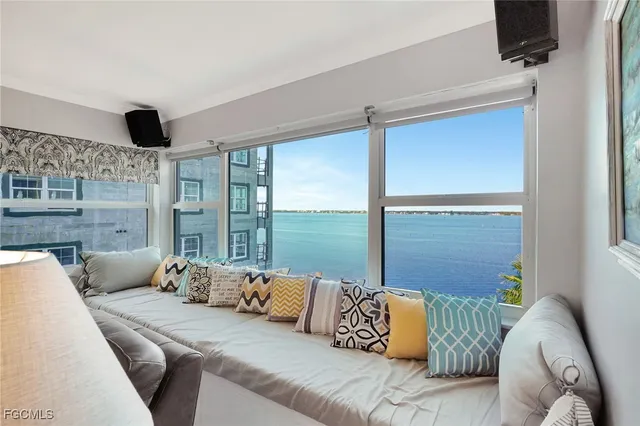 a living room with furniture and large windows