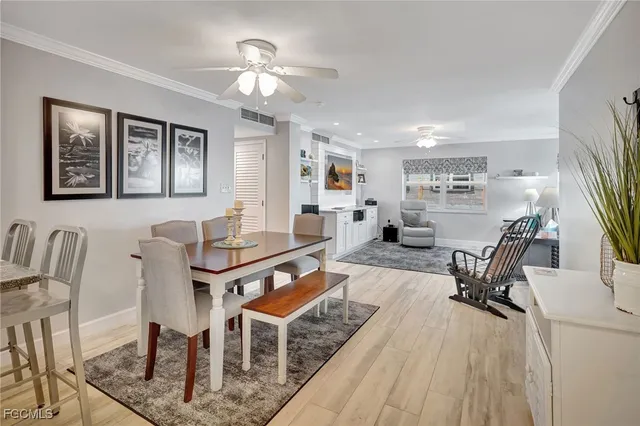a living room with furniture a dining table and wooden floor