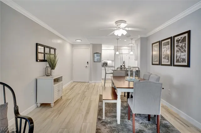 a view of a dining room with furniture and chandelier