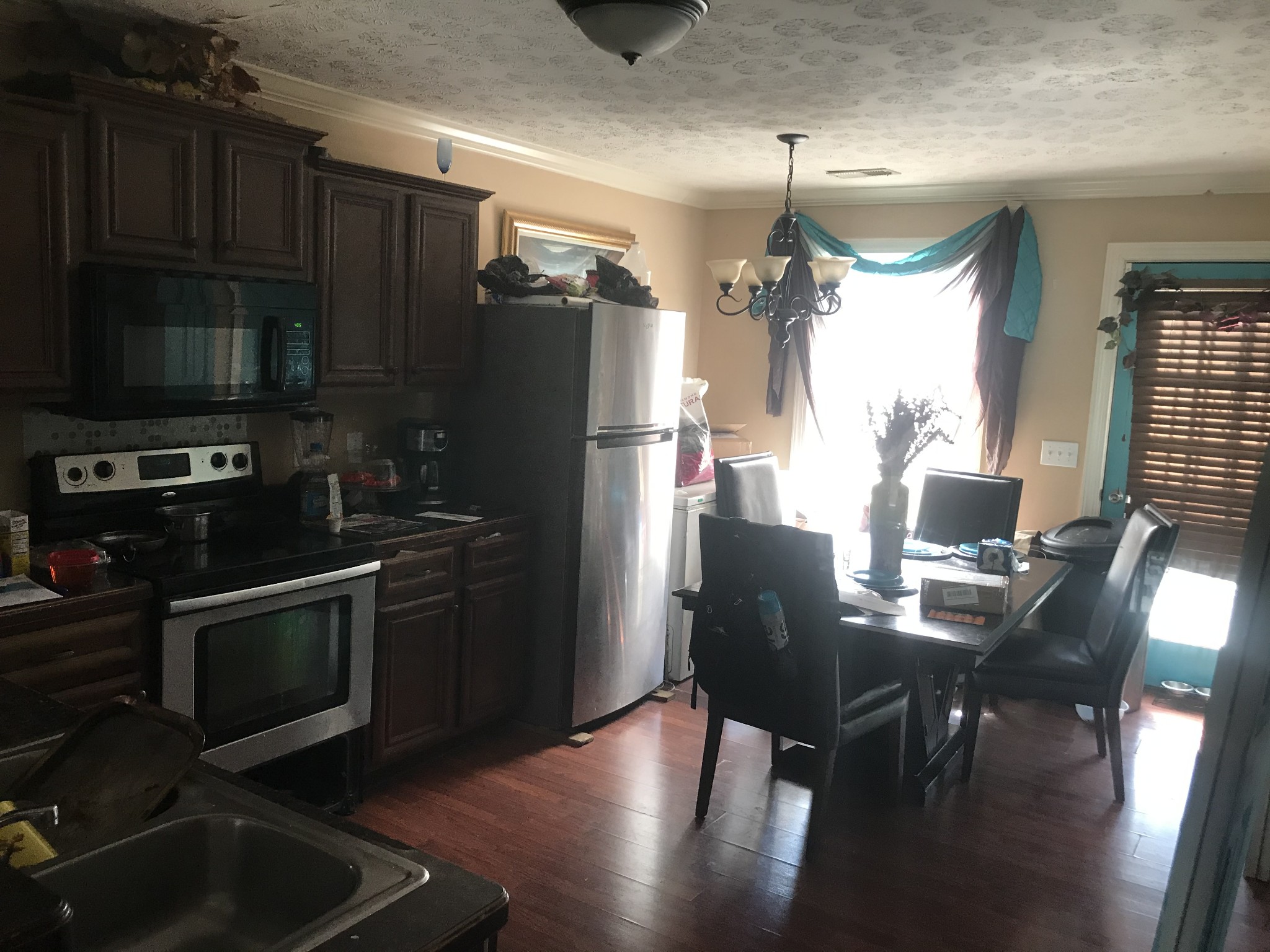 224 Larkin Springs Road Madison, TN 37115 - Photo 3 of 6 a kitchen with granite countertop a refrigerator stove top oven dining table and chairs