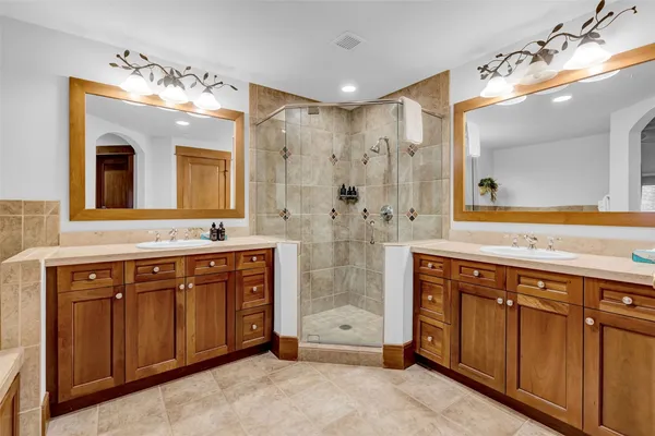a bathroom with a sink vanity granite and a mirror