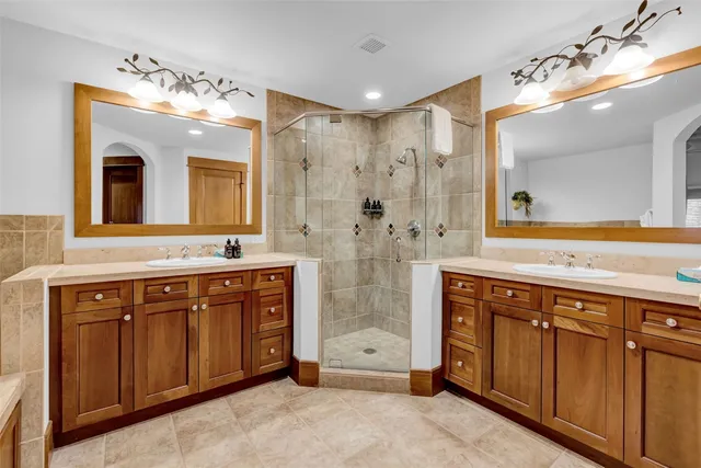 a spacious bathroom with a shower sink and mirror