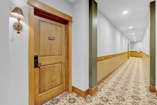 a view of a hallway with wooden floor