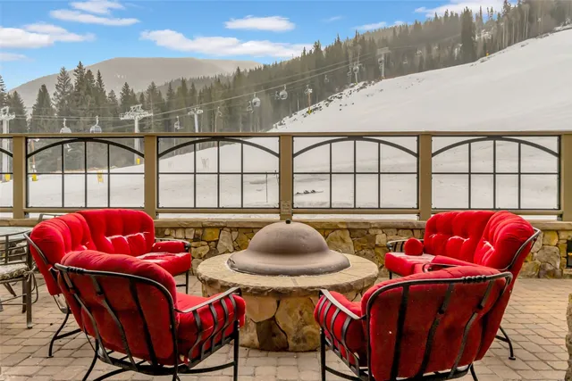 a balcony with table and chairs