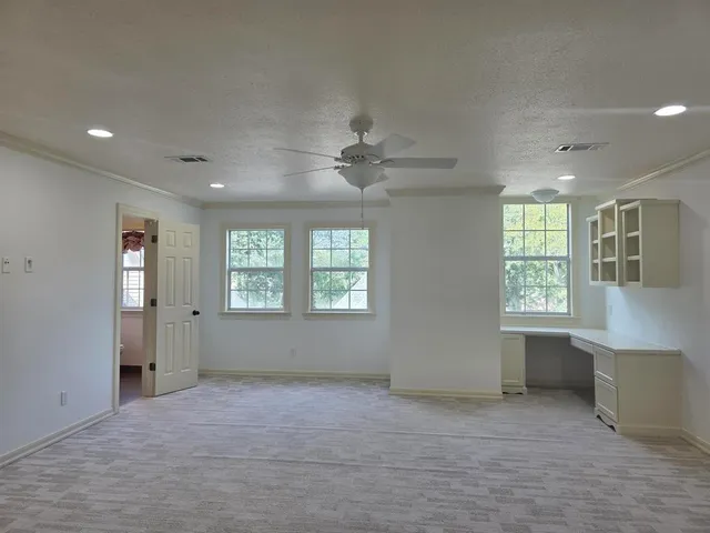 a bathroom with a granite countertop toilet sink and mirror