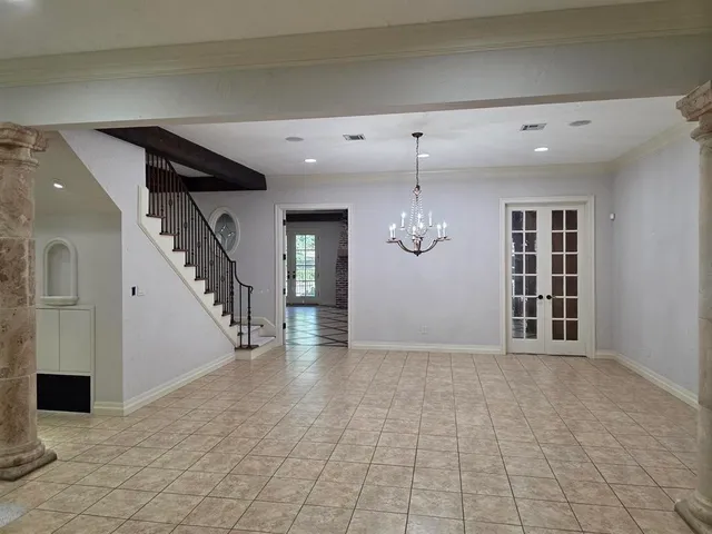 a view of a room with a chandelier and fireplace