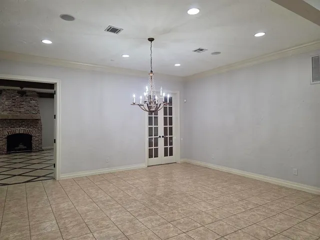 a view of an empty room with a fireplace and a window
