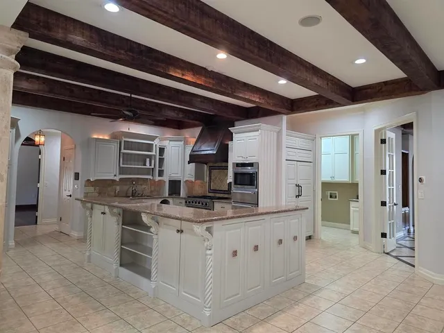 a bathroom with a granite countertop sink a toilet and shower