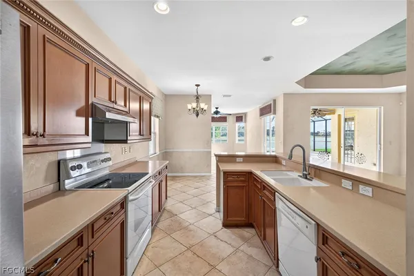 a kitchen with stainless steel appliances granite countertop a sink stove and cabinets