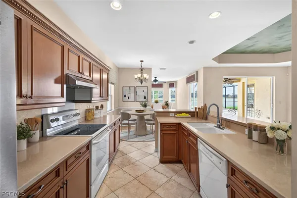 a kitchen with lots of counter top space sink and stainless steel appliances