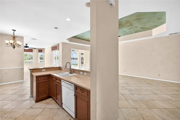 a kitchen with stainless steel appliances granite countertop a sink and a stove