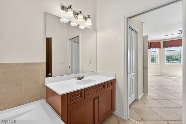 a bathroom with a sink vanity and a mirror