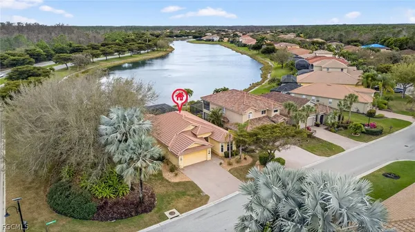 an aerial view of a house with outdoor space and lake view