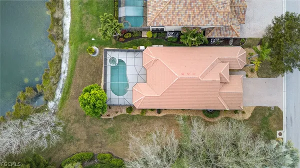 an aerial view of a house with a yard basket ball court and outdoor seating