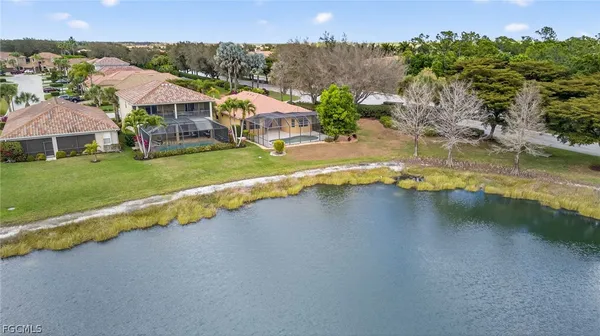 an aerial view of a house with a garden and lake view