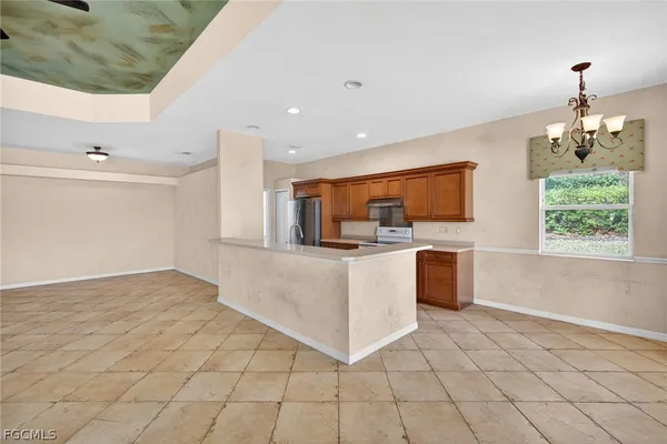 a view of kitchen with stainless steel appliances cabinets and outdoor space
