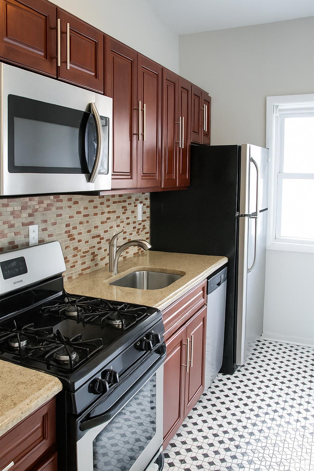 509 Washington Street, Unit 3 Hoboken, NJ 07030 - Photo 1 of 17 a kitchen with a stove and a microwave