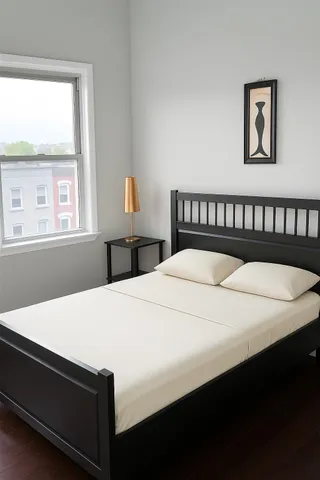 a bedroom with a bed and a window