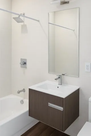 a bathroom with a sink a mirror and a bathtub
