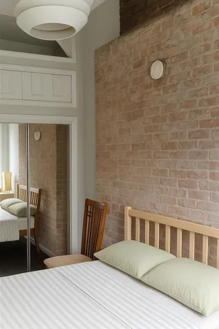 a bedroom with a bed and a table in it