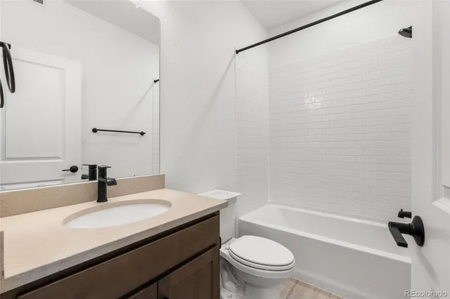 a bathroom with a sink a toilet and a bathtub