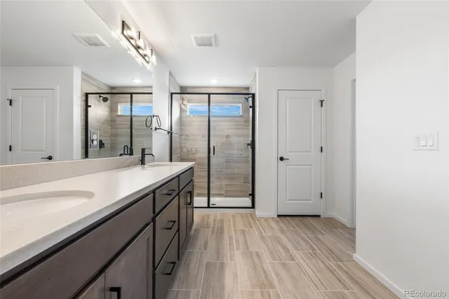 a bathroom with a double vanity sink and mirror