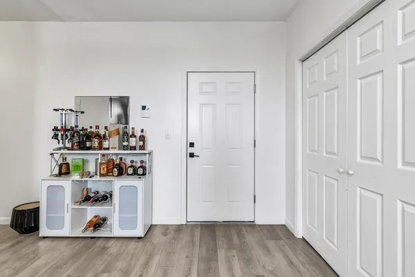 a view of kitchen and entryway with wooden floor