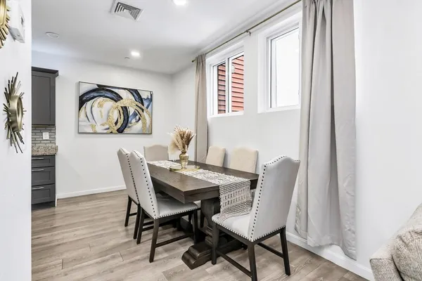 a view of a dining room with furniture and window