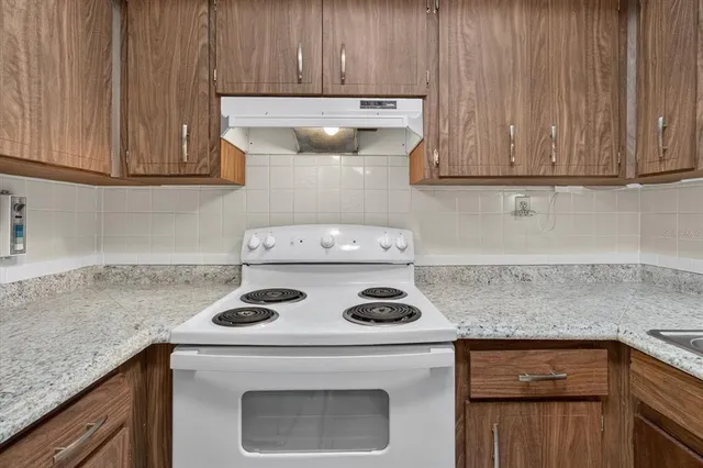 a kitchen with a stove and a cabinets