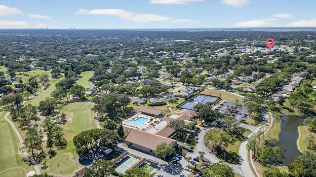 an aerial view of house with yard and mountain view in back