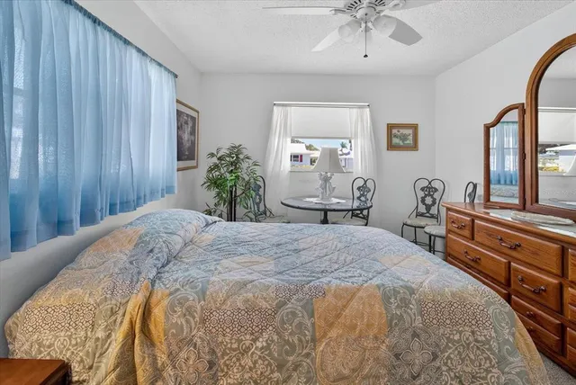 a bedroom with a bed and ceiling fan