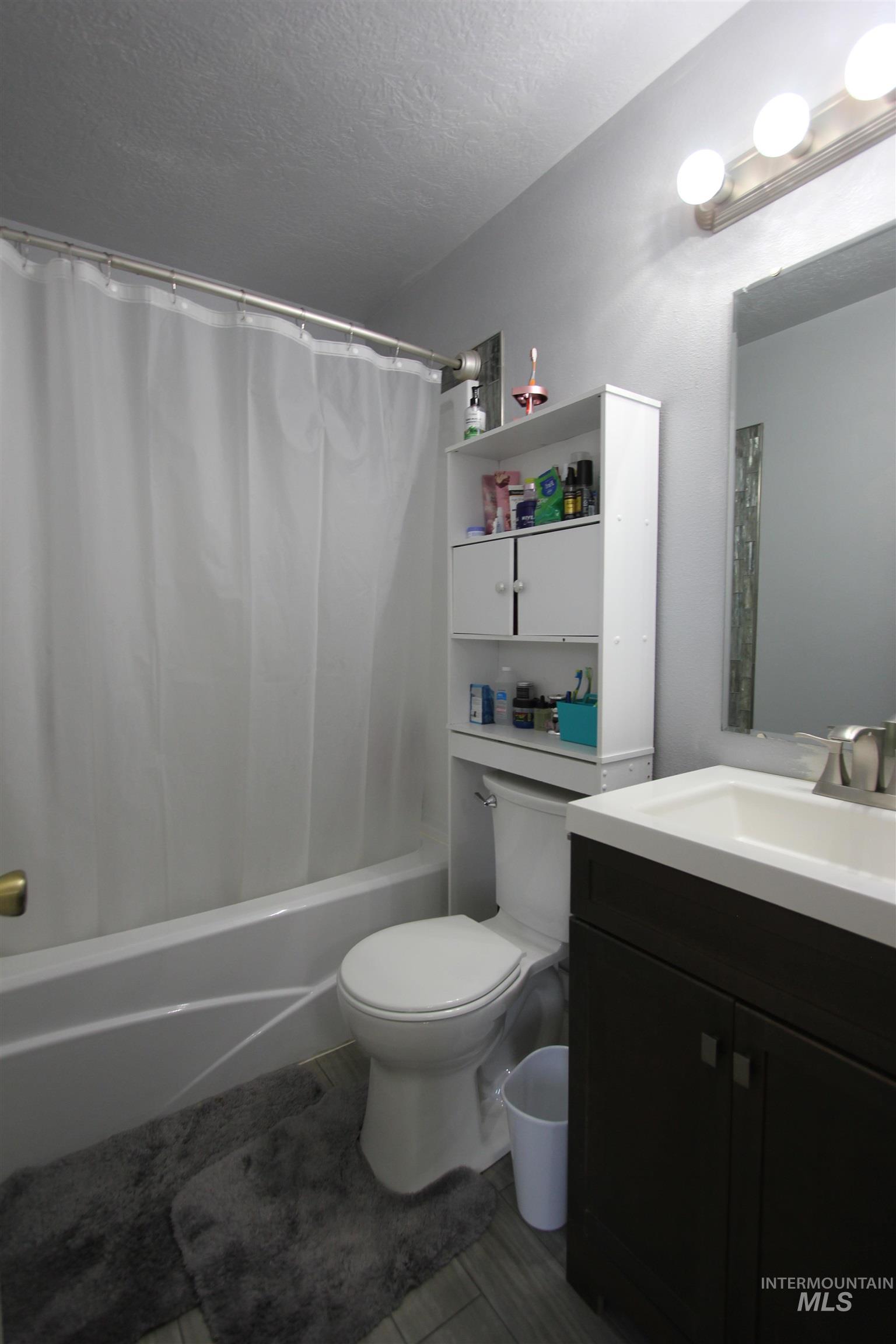 4816 Kadie Street Caldwell, ID 83607 - Photo 16 of 23 Bathroom featuring a white bathtub, toilet, and a vanity with a white rectangular sink
