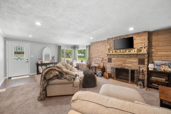 2476 East Washington Road Casey, IL 62420 - Photo 15 of 36 a living room with furniture a fireplace and a flat screen tv