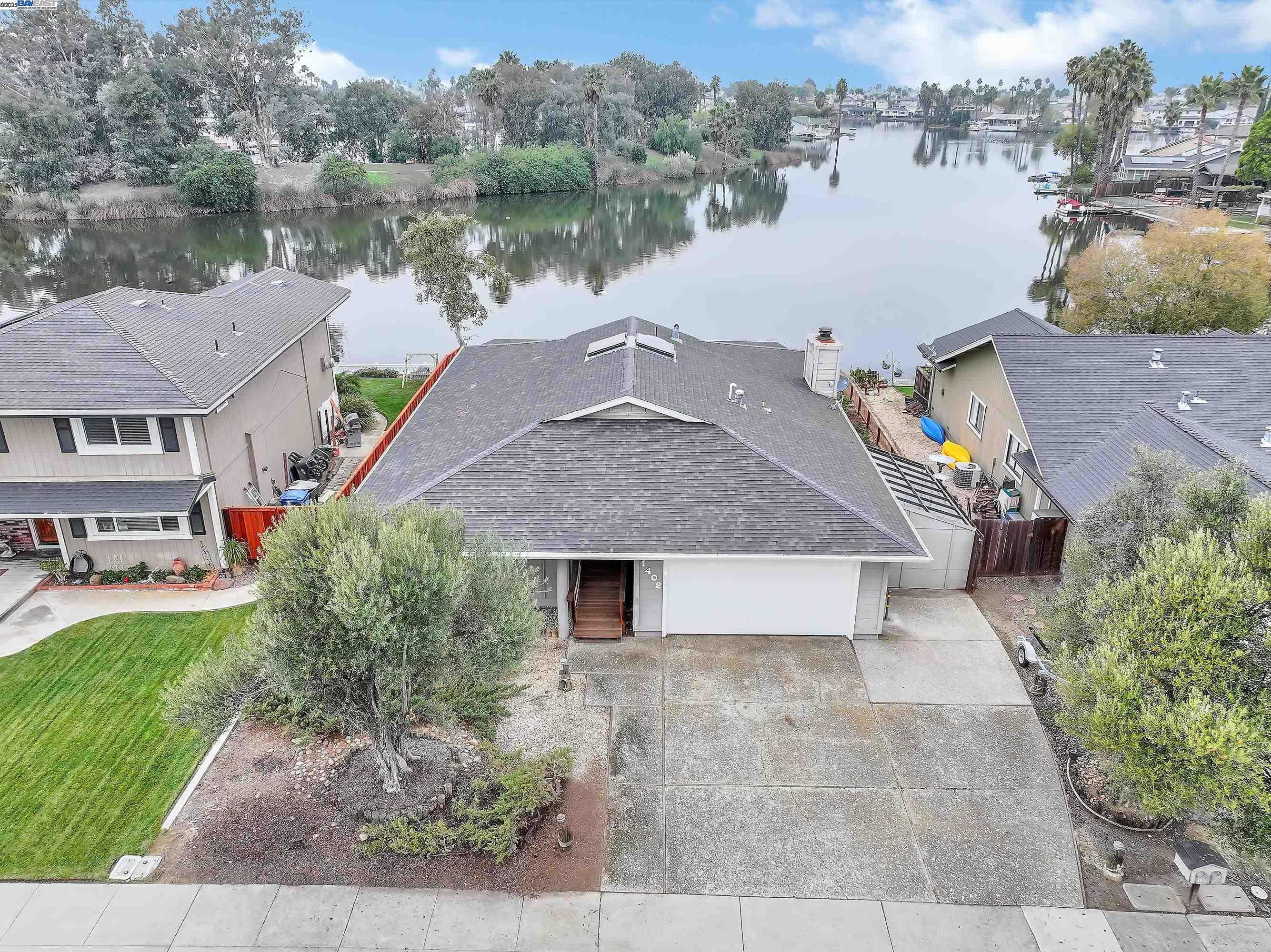 a aerial view of a house with a yard and a fountain