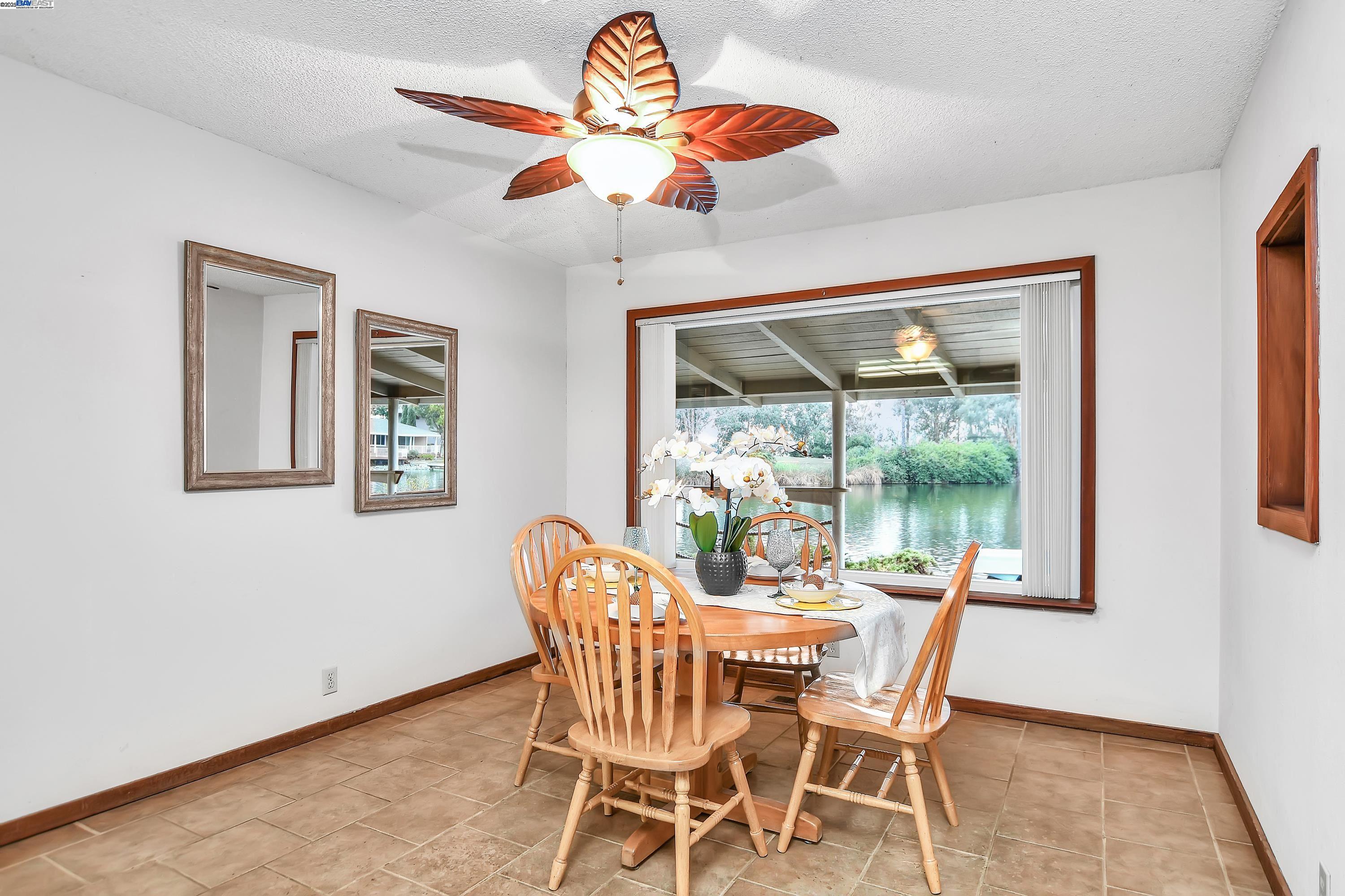 1402 Willow Lake Road Discovery Bay, CA 94505 - Photo 11 of 33 a dining room with furniture a chandelier and wooden floor