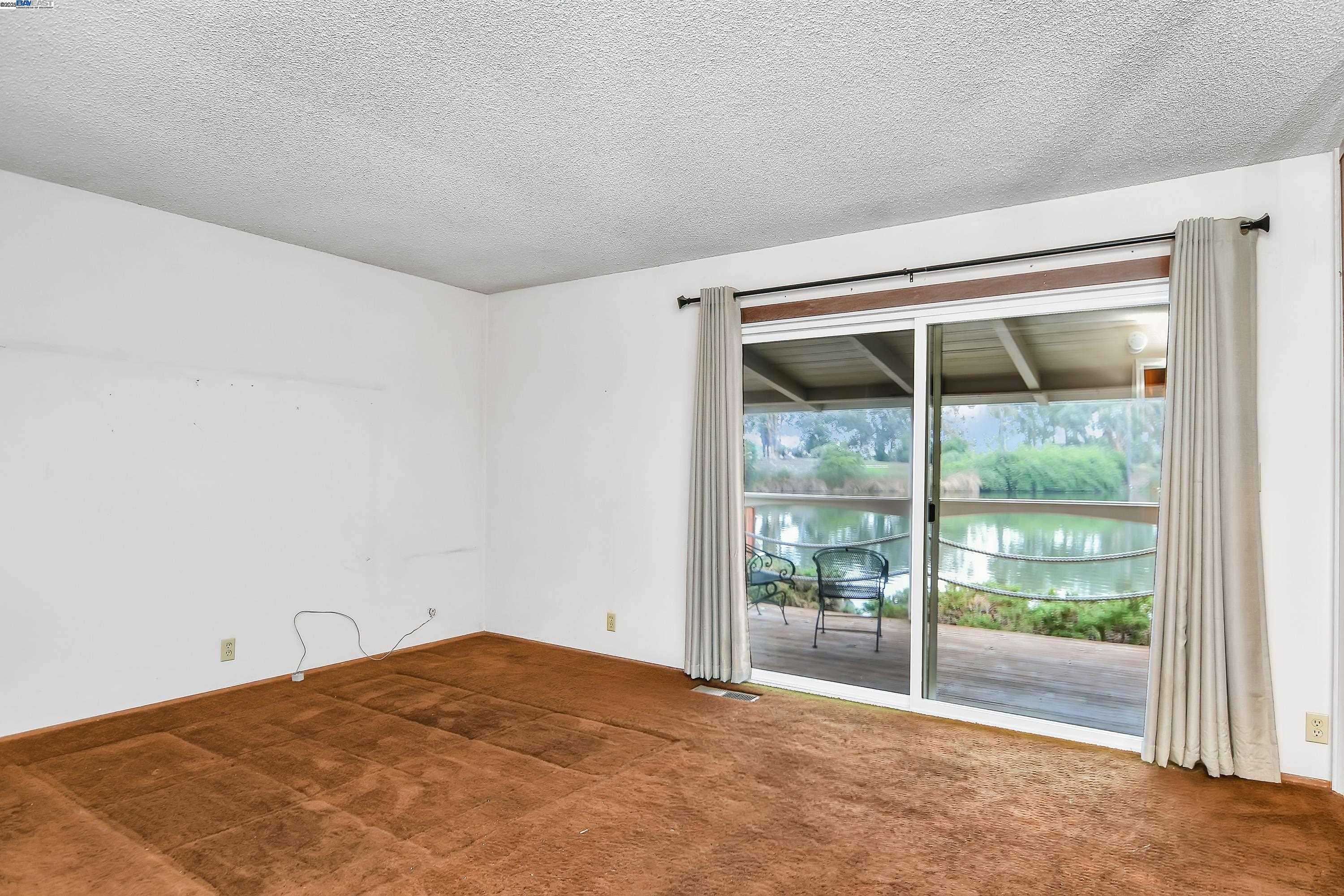 1402 Willow Lake Road Discovery Bay, CA 94505 - Photo 14 of 33 a view of an empty room and window