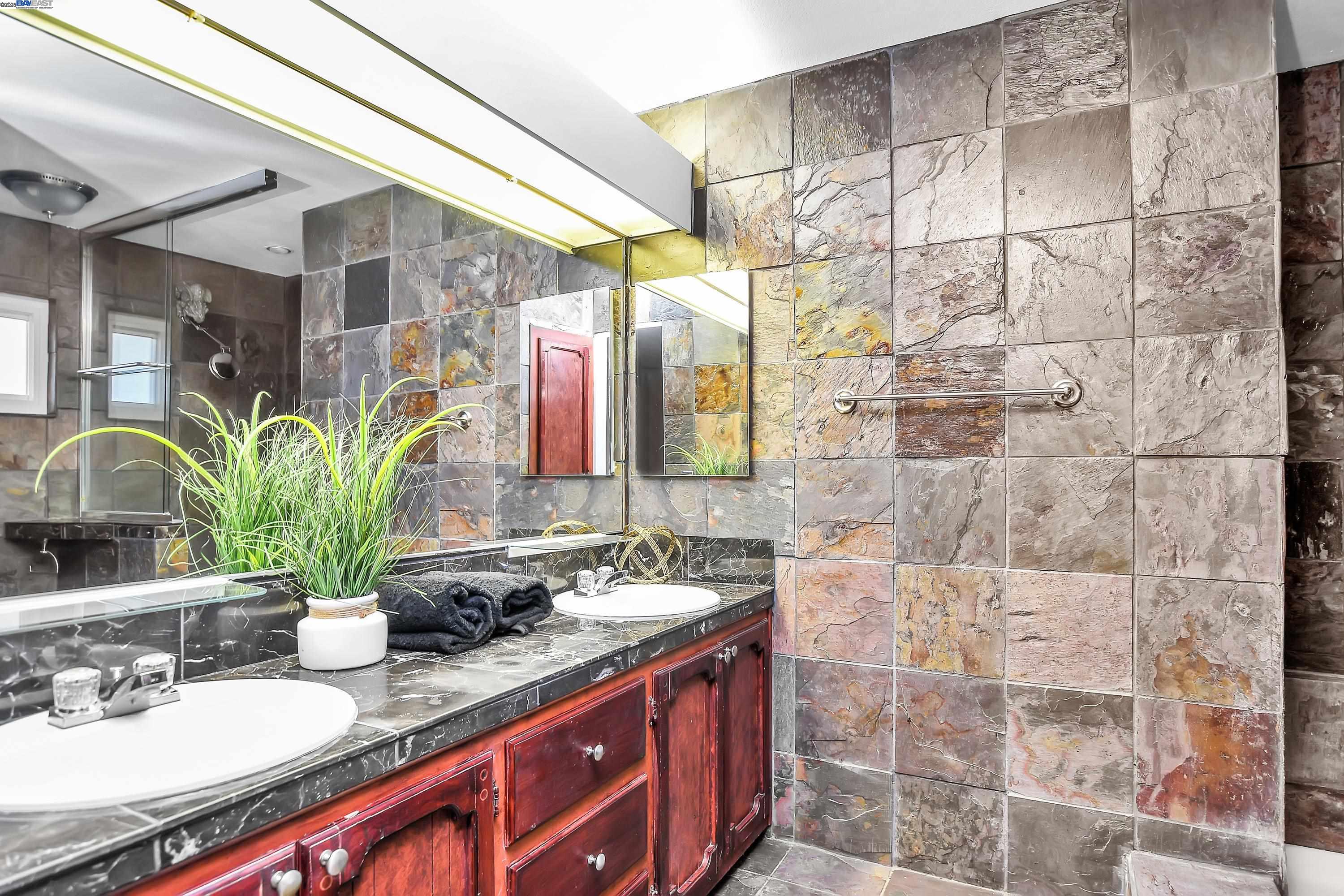 1402 Willow Lake Road Discovery Bay, CA 94505 - Photo 16 of 33 a bathroom with a granite countertop sink a mirror and shower