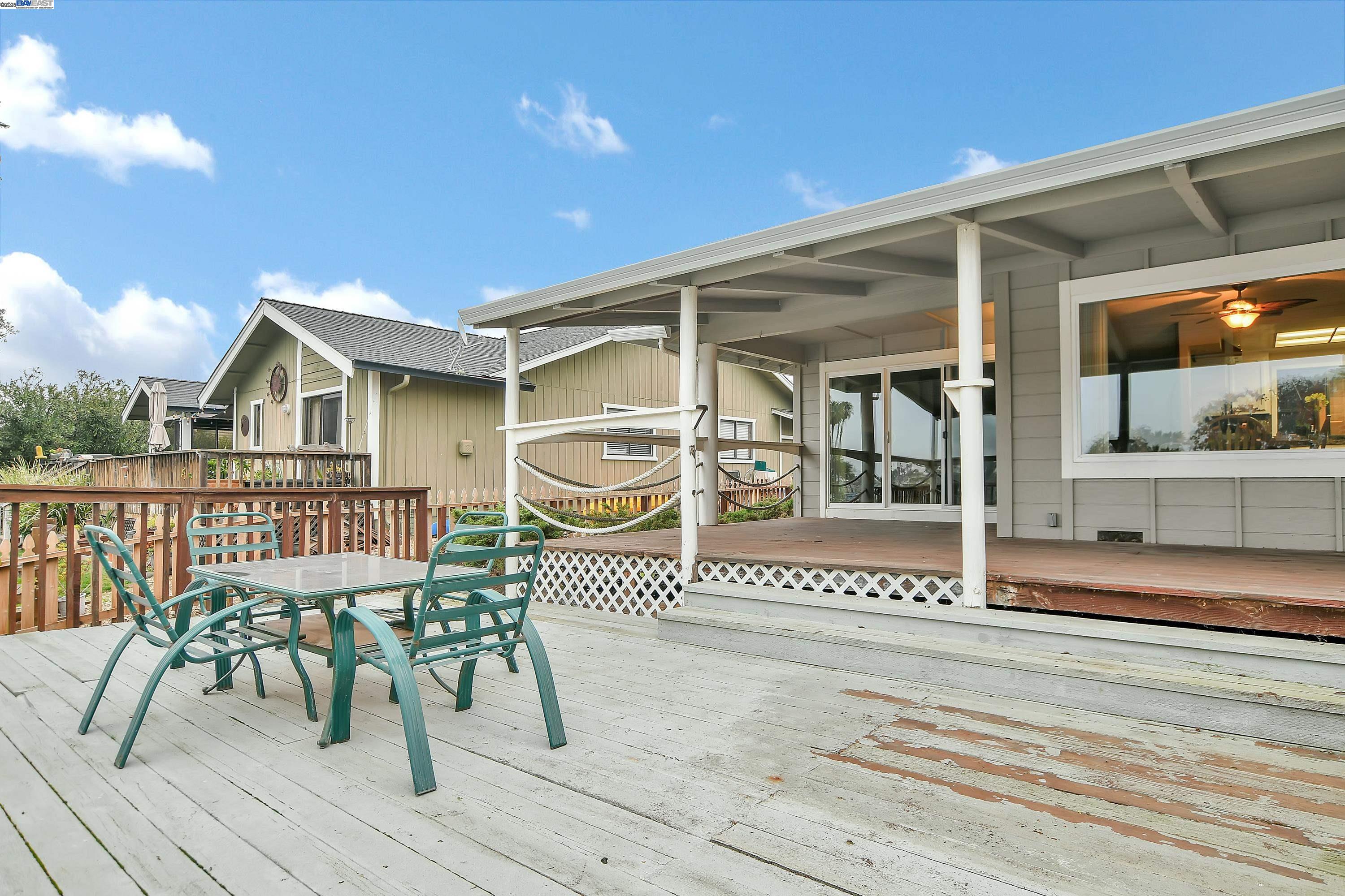 1402 Willow Lake Road Discovery Bay, CA 94505 - Photo 27 of 33 a view of a house with wooden deck and furniture