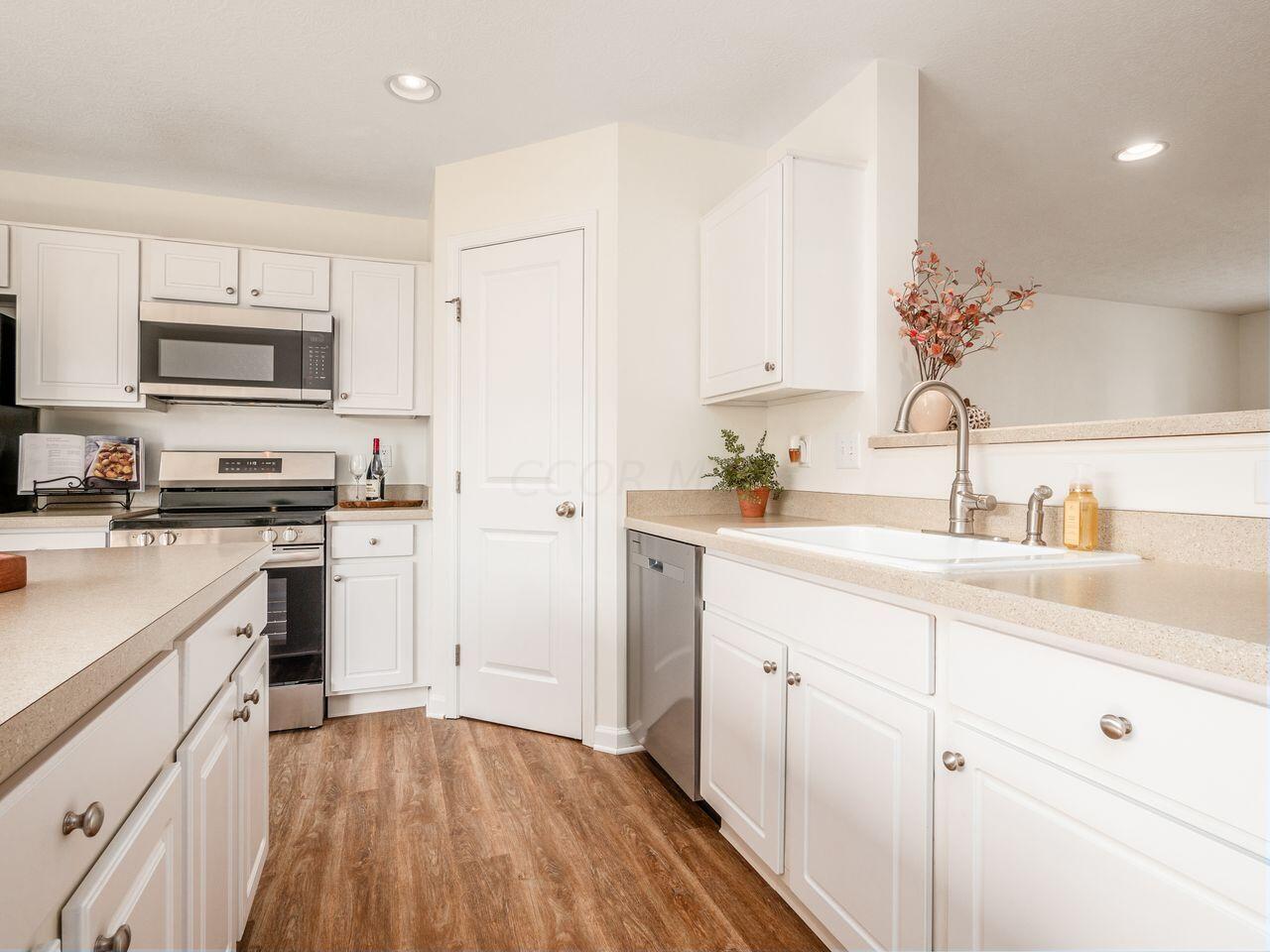 6305 Needletail Road, Unit 25 Columbus, OH 43230 - Photo 6 of 49 Kitchen includes a new stainless steel dishwasher and a large corner pantry.