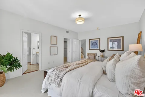a bedroom with a bed and a couch