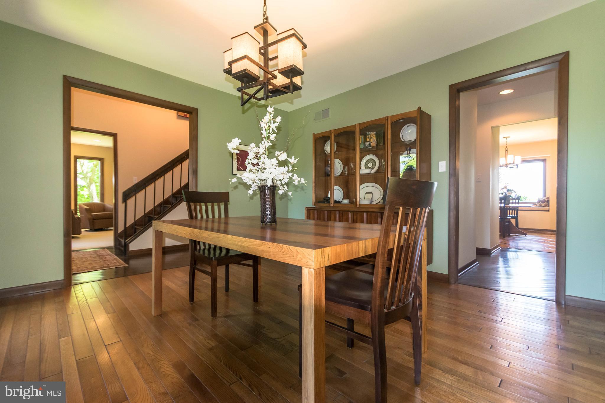 16520 York Road Monkton, MD 21111 - Photo 5 of 30 a dining room with wooden floor a chandelier a wooden table and chairs