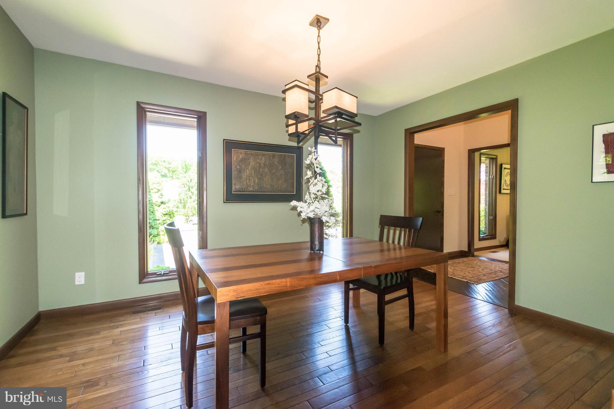 16520 York Road Monkton, MD 21111 - Photo 7 of 30 a dining room with wooden floor a chandelier a wooden table and chairs
